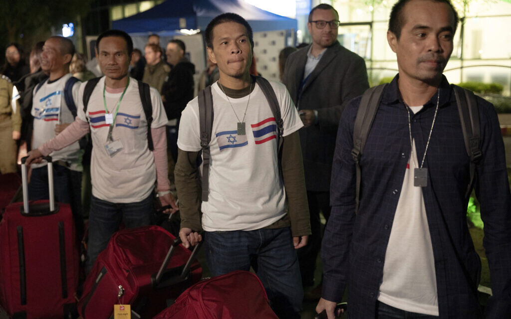 Thai nationals walk to a bus as they leave the Shamir Hospital in Ramle, Israel, November 29, 2023, on their way back to Thailand, after being kidnapped and held by Hamas terrorists for over six weeks. (AP Photo/Maya Levin)