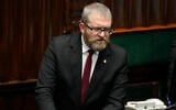 Far-right Polish lawmaker Grzegorz Braun speaks to parliament in Warsaw, Poland, on December 11, 2023. (AP Photo/ Czarek Sokolowski)