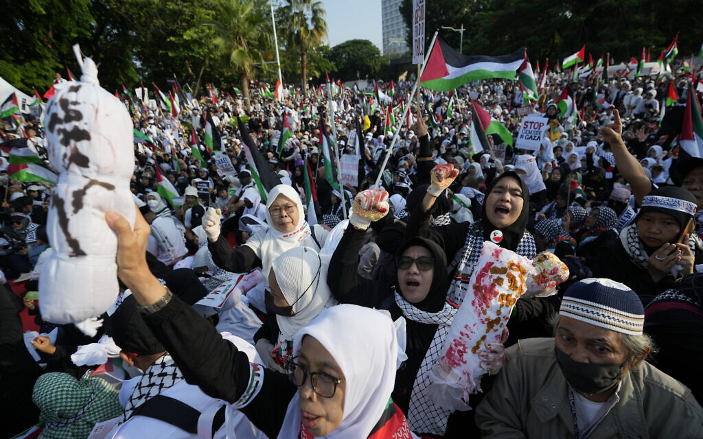 A protester holds up a mock body to represent children killed in Israeli airstrikes on Gaza during an anti-Israel, pro-Palestinian rally outside the US Embassy in Jakarta, Indonesia, Dec 17, 2023. (AP Photo/Achmad Ibrahim)
