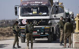 Israeli soldiers check an Egyptian truck carrying humanitarian aid for the Gaza Strip, at the Kerem Shalom Crossing, December 22, 2023. (AP Photo/Maya Alleruzzo)