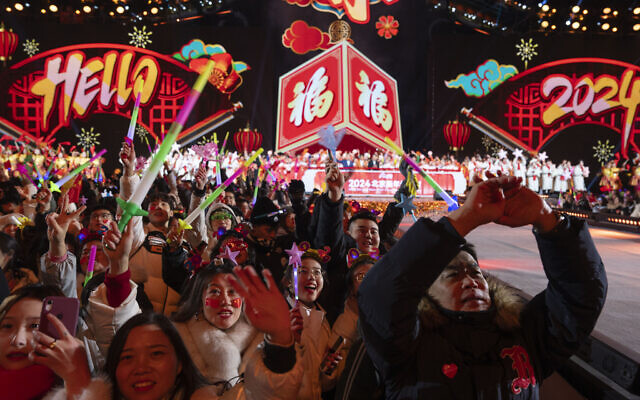 Revelers ring in the new year after a countdown to 2024 in Beijing, Monday, Jan. 1, 2024. (AP Photo/Ng Han Guan) Revelers ring in the new year after a countdown to 2024 in Beijing, Monday, Jan. 1, 2024. (AP Photo/Ng Han Guan)