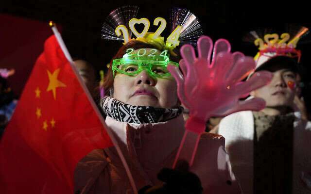 Revelers prepare for a countdown to the new year in Beijing, Sunday, Dec. 31, 2023. (AP Photo/Ng Han Guan) Revelers prepare for a countdown to the new year in Beijing, Sunday, Dec. 31, 2023. (AP Photo/Ng Han Guan)