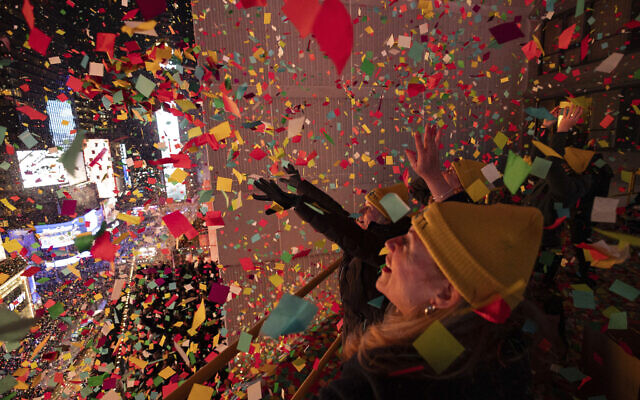 Times Square Alliance volunteers throw confetti as the clock strikes midnight as seen from the New York Marriott Marquis during the New Year's Eve celebration in Times Square, Monday, Jan. 1, 2024, in New York. (AP Photo/Yuki Iwamura)