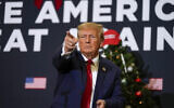 Former US president Donald Trump points to supporters during rally December 19, 2023, in Waterloo, Iowa. (AP Photo/Charlie Neibergall, File)
