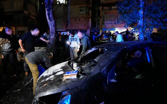 People inspecting body parts following a massive explosion in the southern suburb of Beirut, Lebanon, on Tuesday, January 2, 2024. (AP Photo/Hassan Ammar) People inspecting body parts following a massive explosion in the southern suburb of Beirut, Lebanon, on Tuesday, January 2, 2024. (AP Photo/Hassan Ammar)