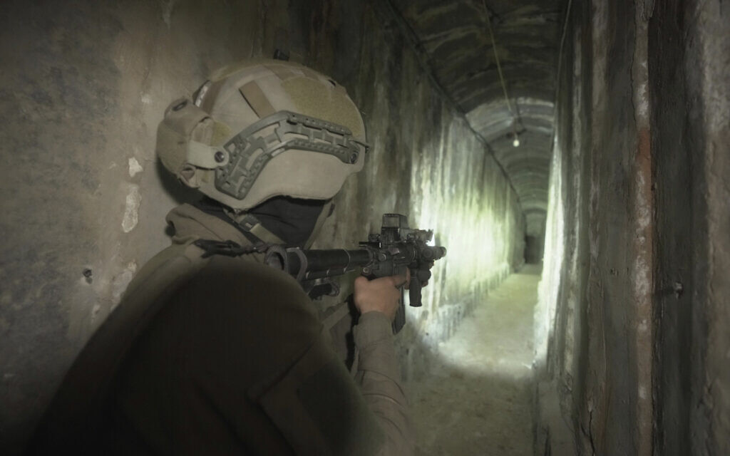 Israeli soldiers show the media an underground tunnel found underneath Shifa Hospital in Gaza City, November 22, 2023. (AP/Victor R. Caivano, File)