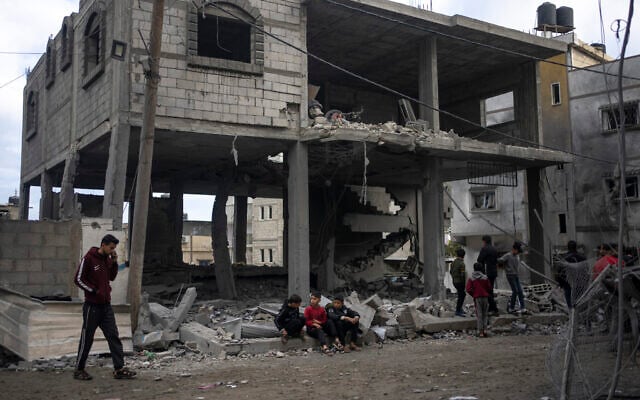 Palestinians look at the destruction after an Israeli strike in Rafah, southern Gaza Strip, Wednesday, Jan. 3, 2024. (AP/Fatima Shbair)