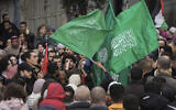 Palestinian demonstrators wave Hamas flags and shout slogans during a protest following the killing of top Hamas official Saleh Arouri in Beirut, in the West Bank city of Ramallah, January 3, 2024. (AP/Mahmoud Illean)
