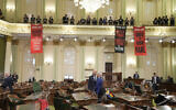 Assembly members Heath Flora, left, and Josh Lowenthal, right, leave the Assembly chambers as pro-Palestinian, anti-Israel protesters calling for a ceasefire in Gaza disrupt the first day of the California legislative session in Sacramento, California, January 3, 2024. (Rich Pedroncelli/AP)