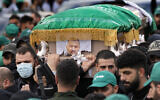 Hamas members carry the coffin of Saleh al-Arouri, one of the top Hamas terror group commanders, who was killed in an apparent Israeli strike Tuesday, during his funeral in Beirut, Lebanon, Jan. 4, 2024. (AP/Hussein Malla)