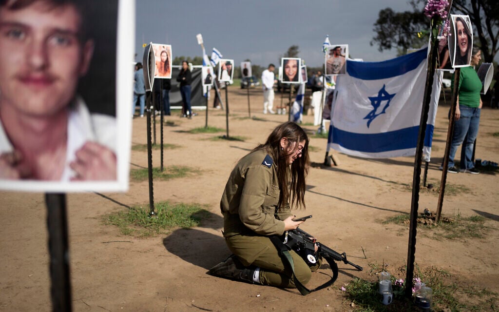An Israeli soldier weeps at a memorial site for those killed and kidnapped in the massacre at the Nova rave on Oct. 7 after a press conference at the site in Re'im, Jan. 5, 2024. (AP Photo/Maya Alleruzzo)