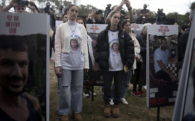 Relatives of victims and hostages captured or killed on Oct. 7 by Hamas at the Nova music festival, listen to a press conference at the site in Re'im, southern Israel, Friday, Jan. 5, 2024. (AP Photo/Maya Alleruzzo)
