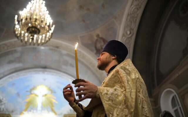 A Russian Orthodox Church priest makes the sign of the cross during an Orthodox Christmas service at the Church of the Holy Martyr Tatiana near the Kremlin Wall in Moscow, Russia, late Saturday, Jan. 6, 2024. (AP/Alexander Zemlianichenko) A Russian Orthodox Church priest makes the sign of the cross during an Orthodox Christmas service at the Church of the Holy Martyr Tatiana near the Kremlin Wall in Moscow, Russia, late Saturday, Jan. 6, 2024. (AP/Alexander Zemlianichenko)