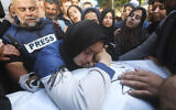 Family members mourn Hamza Dahdouh, who worked for Al Jazeera and who was killed in an Israeli airstrike in Rafah, Gaza Strip, January 7, 2024 (AP Photo/Hatem Ali) (AP Photo/Hatem Ali)