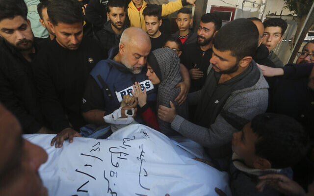 Al Jazeera journalist Wael Dahdouh holds the hand of his son Hamza, who also worked for Al Jazeera and who was killed in a purported Israeli airstrike in Rafah, Gaza Strip, Jan. 7, 2024. (AP Photo/Hatem Ali) Al Jazeera journalist Wael Dahdouh holds the hand of his son Hamza, who also worked for Al Jazeera and who was killed in a purported Israeli airstrike in Rafah, Gaza Strip, Jan. 7, 2024. (AP Photo/Hatem Ali)