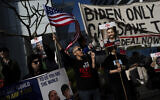 Families and supporters of Israeli hostages held by Hamas terrorists in Gaza hold signs and photos of their loved ones at a protest calling for their return, outside a meeting between US Secretary of State Antony Blinken and President Isaac Herzog, in Tel Aviv, January 9, 2024. (AP/Oded Balilty)