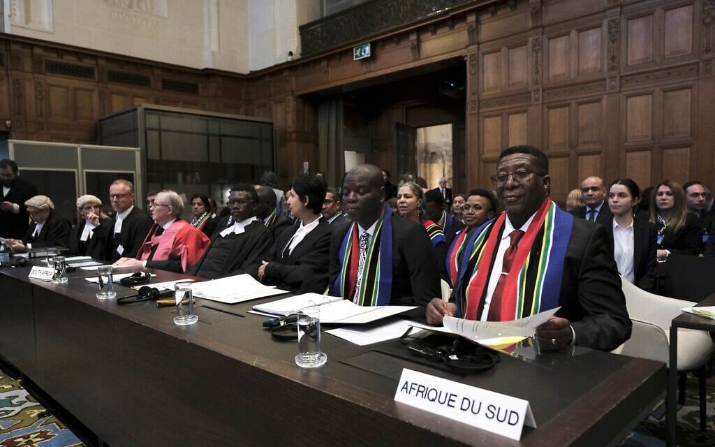 Ambassador of the Republic of South Africa to the Netherlands Vusimuzi Madonsela, right, and Minister of Justice and Correctional Services of South Africa Ronald Lamola, center, during the opening of the hearings at the International Court of Justice in The Hague, Netherlands, Jan. 11, 2024.  (AP Photo/Patrick Post)