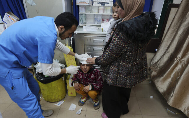 A Palestinian child wounded in an Israeli airstrike is brought to Al Aqsa Hospital in Deir al Balah, Gaza Strip, on Thursday, Jan. 11, 2024. (AP Photo/Adel Hana) A Palestinian child wounded in an Israeli airstrike is brought to Al Aqsa Hospital in Deir al Balah, Gaza Strip, on Thursday, Jan. 11, 2024. (AP Photo/Adel Hana)