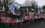 Protesters waving flags and pictures of the hostages kidnapped during the Oct. 7 Hamas cross-border attack in Israel, attend a protest outside the International Court of Justice in The Hague, Netherlands, Friday, Jan. 12, 2024. (AP Photo/Patrick Post)