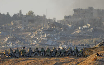 Israeli soldiers take positions near the Gaza Strip border in southern Israel, December 11, 2023. (AP/Ohad Zwigenberg)