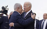 US President Joe Biden is greeted by Prime Minister Benjamin Netanyahu (right) after arriving at Ben Gurion International Airport, on October 18, 2023, in Tel Aviv. (AP/Evan Vucci)