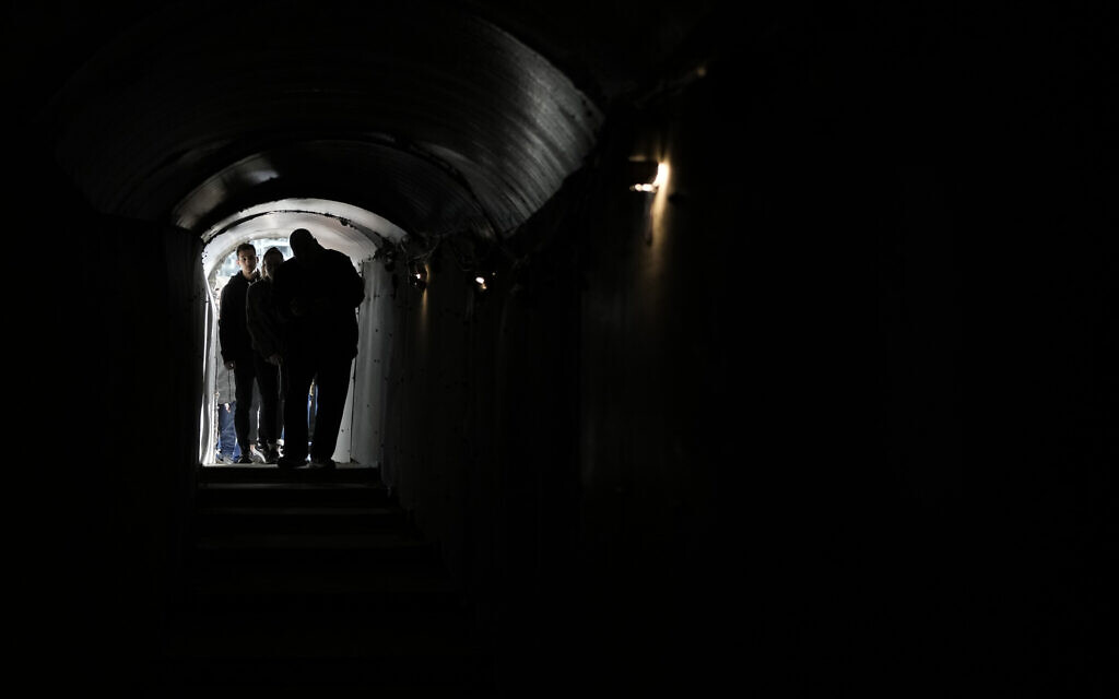 People walk through an installation simulating a tunnel in Gaza in an act of solidarity with hostages believed to be held underground by Hamas and calling for their return, in Tel Aviv, Israel, Saturday Jan. 13, 2024. Sunday marks 100 days since Hamas’s cross-border attack on Oct. 7 in which the terror group killed some 1,200 people in southern Israel, mostly civilians, and took 250 others hostage. (AP Photo/Leo Correa)