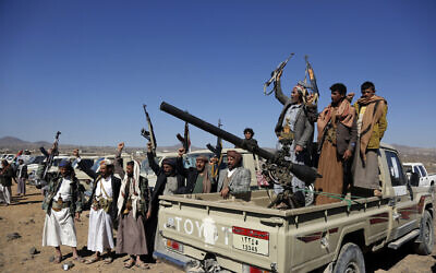 Houthi fighters and tribesmen stage a rally against the US and the UK strikes on Houthi-run military sites near Sanaa, Yemen, on Sunday, January 14, 2024. (AP)
