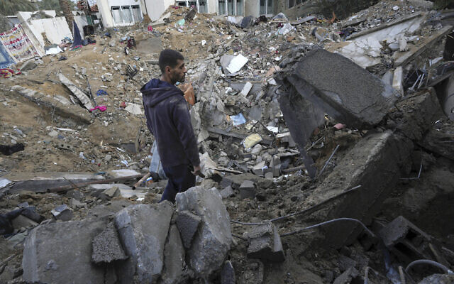 A Palestinian looks at the destruction after an Israeli strike at a residential building in Deir al Balah, Gaza Strip, Sunday, January 14, 2024. (AP Photo/Adel Hana) A Palestinian looks at the destruction after an Israeli strike at a residential building in Deir al Balah, Gaza Strip, Sunday, January 14, 2024. (AP Photo/Adel Hana)