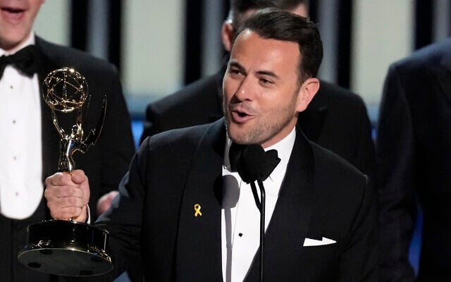 Ben Winston accepts the award for outstanding variety special (live) for 'Elton John Live: Farewell from Dodger Stadium' during the 75th Primetime Emmy Awards at the Peacock Theater in Los Angeles, January 15, 2024. On his lapel is a yellow ribbon pin highlighting the hostages held by terror group Hamas in the Gaza Strip. (Chris Pizzello/AP) Ben Winston accepts the award for outstanding variety special (live) for 'Elton John Live: Farewell from Dodger Stadium' during the 75th Primetime Emmy Awards at the Peacock Theater in Los Angeles, January 15, 2024. On his lapel is a yellow ribbon pin highlighting the hostages held by terror group Hamas in the Gaza Strip. (Chris Pizzello/AP)