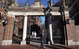File: A passerby walks through a gate to the Harvard University campus in Cambridge, Massachusetts, January 2, 2024. (Steven Senne/AP Photo)
