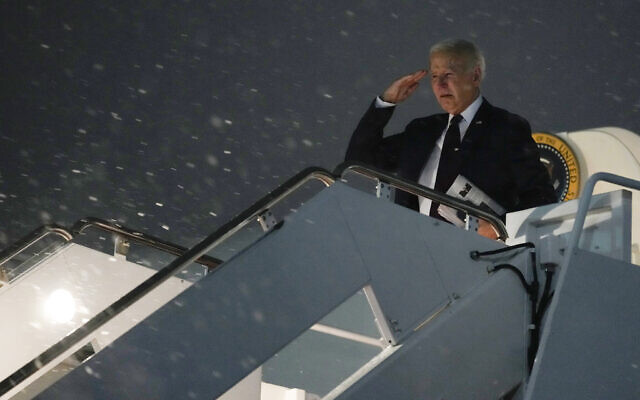 US President Joe Biden salutes as he board Air Force One in the snow at Andrews Air Force Base, Md., Friday, Jan. 19, 2024, to head to Delaware to spend the weekend at his home in Rehoboth Beach. (AP Photo/Susan Walsh)