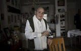 Gad Partok, 93, a Tunisian-born Holocaust survivor, poses for a portrait in his home in Ashkelon, Jan. 26, 2024. (AP Photo/Maya Alleruzzo)
