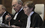 Presiding judge Joan Donoghue, right, opens the session at the International Court of Justice in The Hague, Netherlands, Friday, Jan. 26, 2024. (AP Photo/Patrick Post)