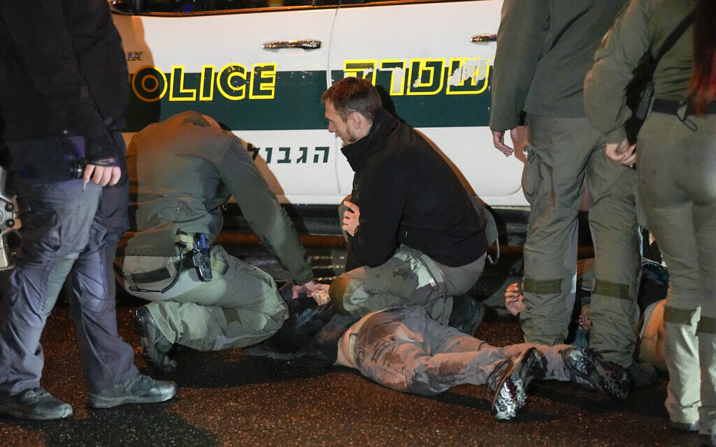 Police detain a man during a demonstration calling for new elections in Tel Aviv, Israel, Saturday, Jan. 27, 2024. (AP Photo/Ariel Schalit)