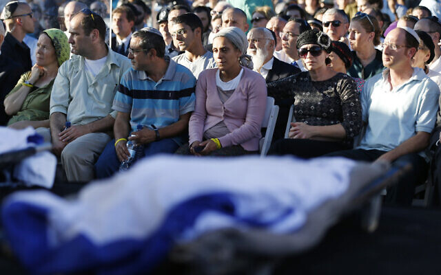 Parents of Naftali Fraenkel, 16, Eyal Yifrah, 19, and Gil-Ad Shaer, 16, (from L-R), the three Israeli teens who were abducted and killed in the West Bank, mourn during their sons' joint funeral in the Israeli city of Modiin, July 1, 2014. (AP/Baz Ratner, Pool)