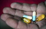 Illustrative photo of a hand holding pharmaceutical pills. (Hadas Parush/Flash90)