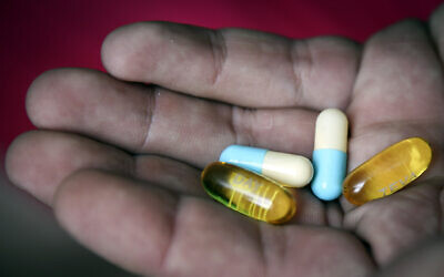 Illustrative photo of a hand holding pharmaceutical pills. (Hadas Parush/Flash90)