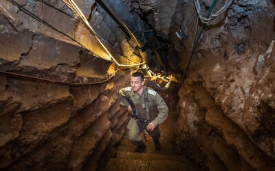 An Israeli soldier stands inside a Hezbollah tunnel that crosses from Lebanon to Israel, on the border between Israel and Lebanon in northern Israel, on May 29, 2019. (Basel Awidat/Flash90)