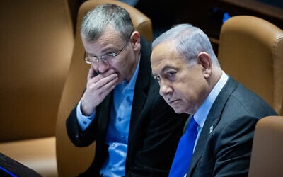Prime Minister Benjamin Netanyahu with Justice Minister Yariv Levin at the Knesset during a discussion and a vote on the state budget in Jerusalem, December 14, 2023. (Yonatan Sindel/Flash90)