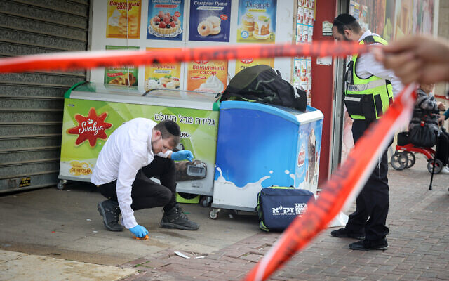 ZAKA volunteers at the scene where a 2-year-old boy was stabbed to death in Lod, December 28, 2023. (Jonathan Shaul/Flash90) ZAKA volunteers at the scene where a 2-year-old boy was stabbed to death in Lod, December 28, 2023. (Jonathan Shaul/Flash90)