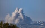Smoke rises after an Israeli air strike in the Gaza Strip, as it seen from the Israeli side of the border, on January 14, 2024. (Chaim Goldberg/Flash90)
