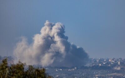 Smoke rises after an Israeli air strike in the Gaza Strip, as it seen from the Israeli side of the border, on January 14, 2024. (Chaim Goldberg/Flash90)
