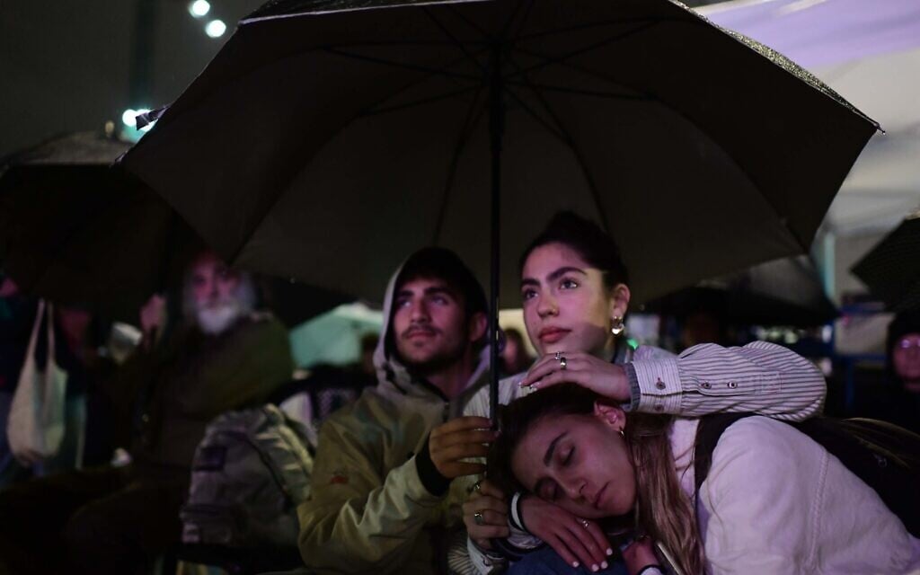 People attend 24-hour rally for hostages marking 100 days since the start of the war between Israel and Hamas, at 'Hostages Square' in Tel Aviv, early on January 14, 2024. (Tomer Neuberg/Flash90) People attend 24-hour rally for hostages marking 100 days since the start of the war between Israel and Hamas, at 'Hostages Square' in Tel Aviv, early on January 14, 2024. (Tomer Neuberg/Flash90)