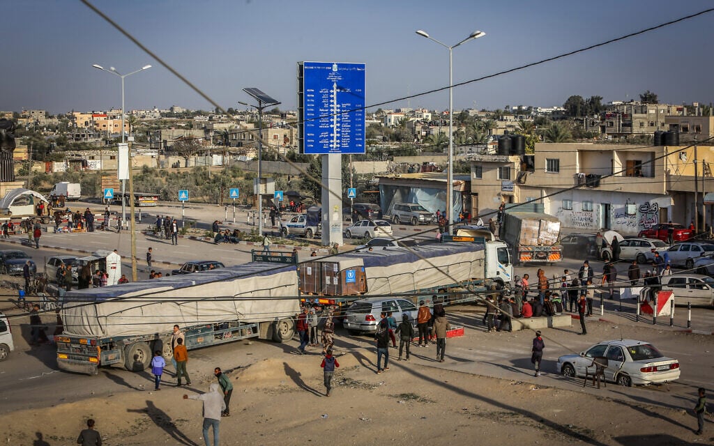 Trucks with aid arrive at the Gazan side of the Kerem Shalom border crossing, in the southern Gaza Strip, on January 17, 2024. (Abed Rahim Khatib/Flash90)