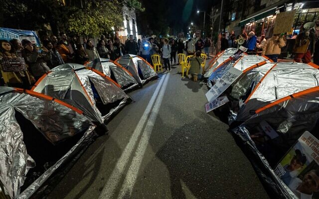 Israelis whose family members are held hostage by Hamas terrorists in Gaza set up tents during a protest outside Prime Minister Benjamin Netanyahu's official residence in Jerusalem, calling for him to do more to secure the release of the hostages, January 21, 2024. (Yonatan Sindel/Flash90)