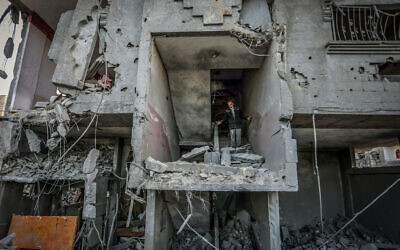 Palestinians at the site of a destroyed building from an Israeli airstrike in Rafah, in the southern Gaza Strip, on January 25, 2024. (Abed Rahim Khatib/Flash90)