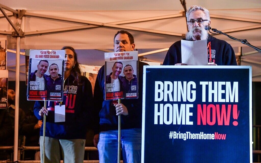 Joseph Avi Yair Engel, right, whose parents were Holocaust survivors and whose grandson was released from captivity in Gaza, speaks at rally calling for the release of the remaining hostages, in Hostages Square in Tel Aviv on January 27, 2024. (Avshalom Sassoni/Flash90) Joseph Avi Yair Engel, right, whose parents were Holocaust survivors and whose grandson was released from captivity in Gaza, speaks at rally calling for the release of the remaining hostages, in Hostages Square in Tel Aviv on January 27, 2024. (Avshalom Sassoni/Flash90)