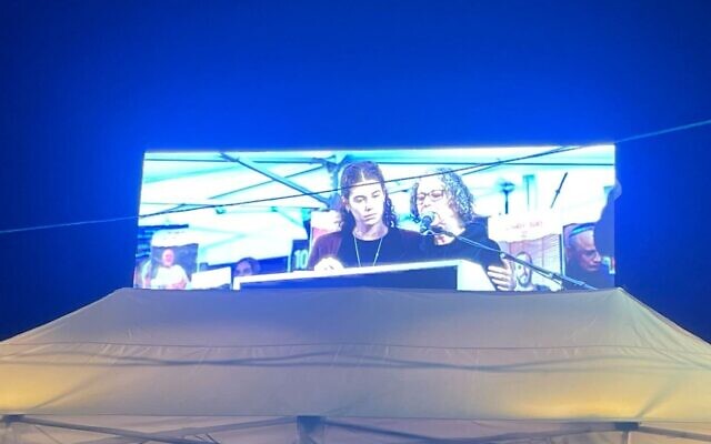 Freed hostage Aviva Siegel and her daughter speak at the 100-day rally in Tel Aviv on January 14, 2024. (Jessica Steinberg/Times of Israel)