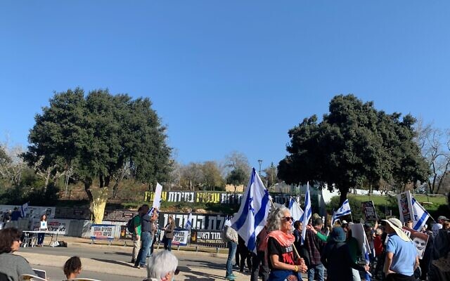 Protesters gather outside the Knesset in opposition to the government on January 22, 2024. (Charlie Summers/Times of Israel)