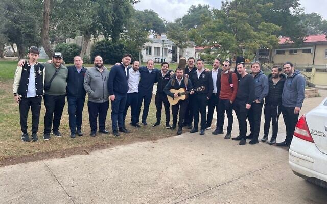 A group of observant Jewish men, mostly from New York and Brooklyn, visit Kibbutz Kfar Aza, close to the Israeli border with Gaza, January 3, 2024. (Sue Surkes/Times of Israel)